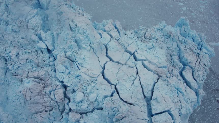 Icebergs tower on the side of water