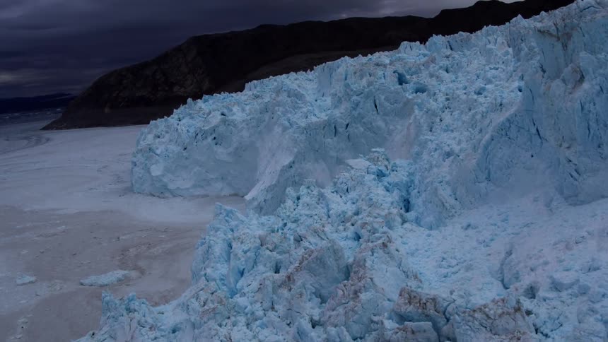 Glaciers stand next to icy water