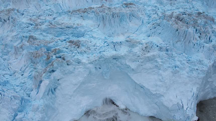The large island of ice is beginning to melt on the edge
