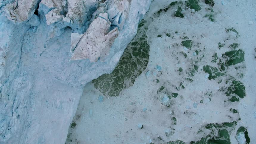 The iceberg is melting giving waves off in the water around it
