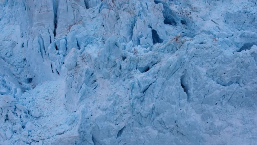 The iceberg is blue and covered with dirt