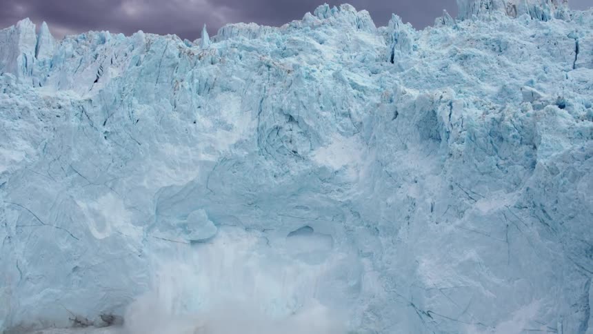 Pieces of ice falling off huge glacier