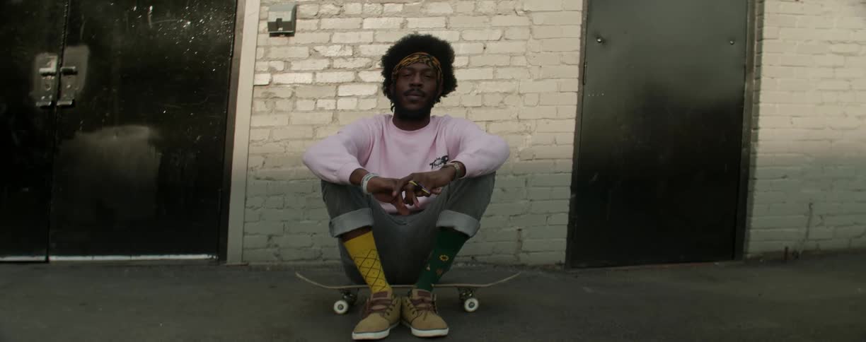 Man sitting on his skateboard