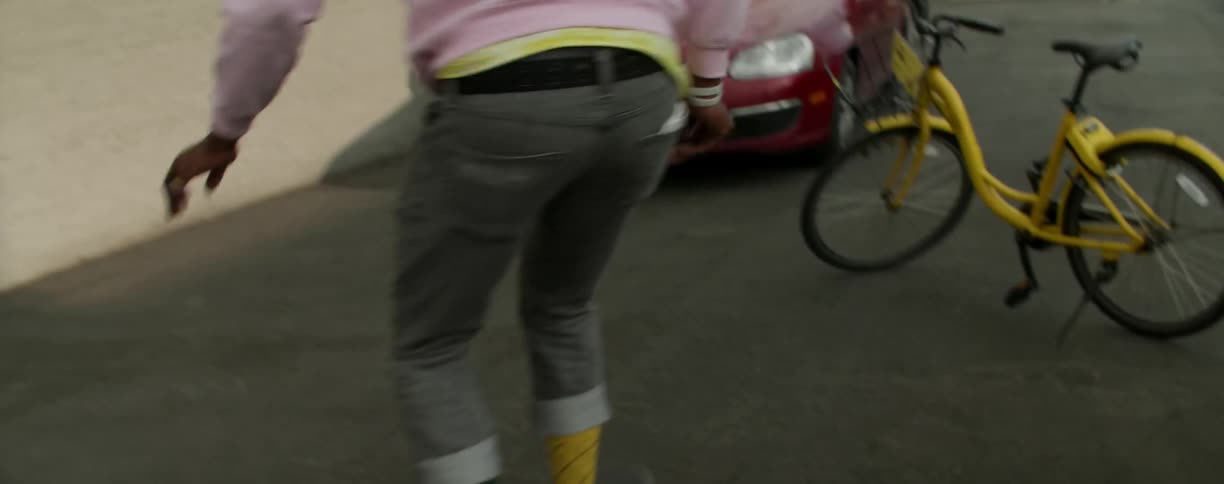 Man jumps over a bicycle as he skateboards