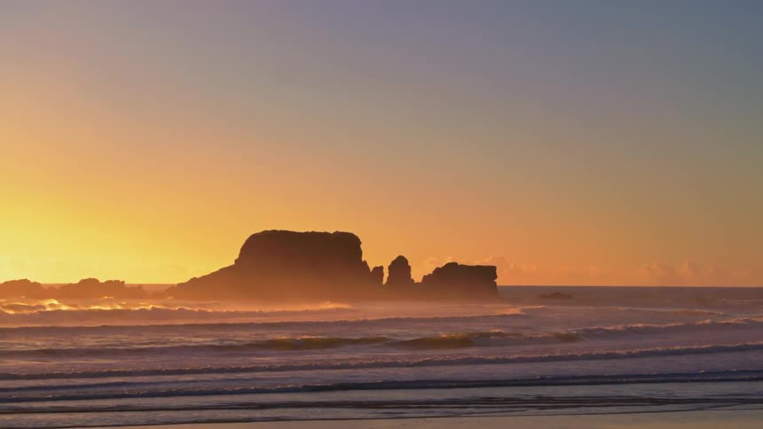 Ocean waves come to shore at sunset