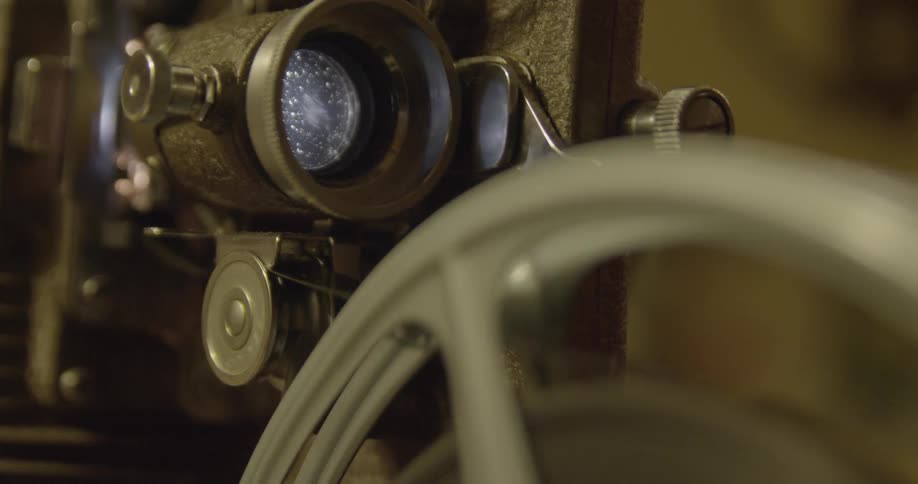 A movie reel rotates on a projector