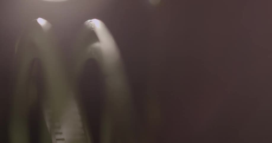 A film reel turning with lights in the background