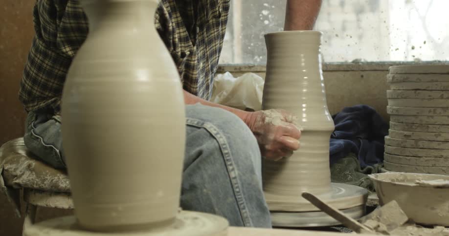 A man working with a pottery wheel