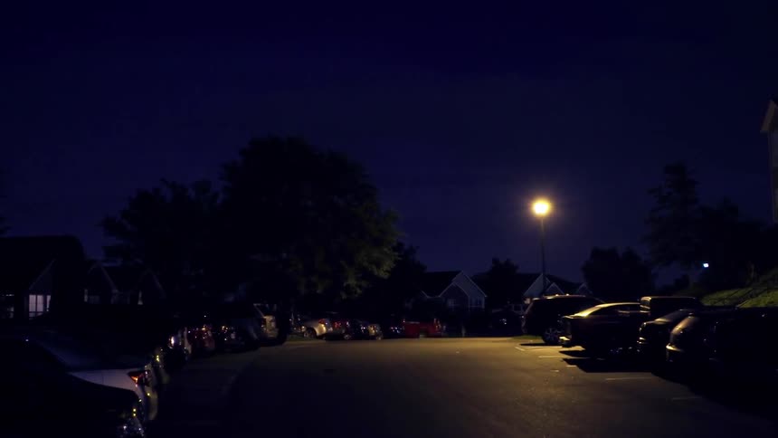 Lightning flashing in the night sky outside of city