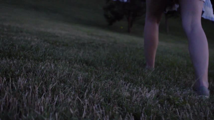 A person slowly walks over the lawn