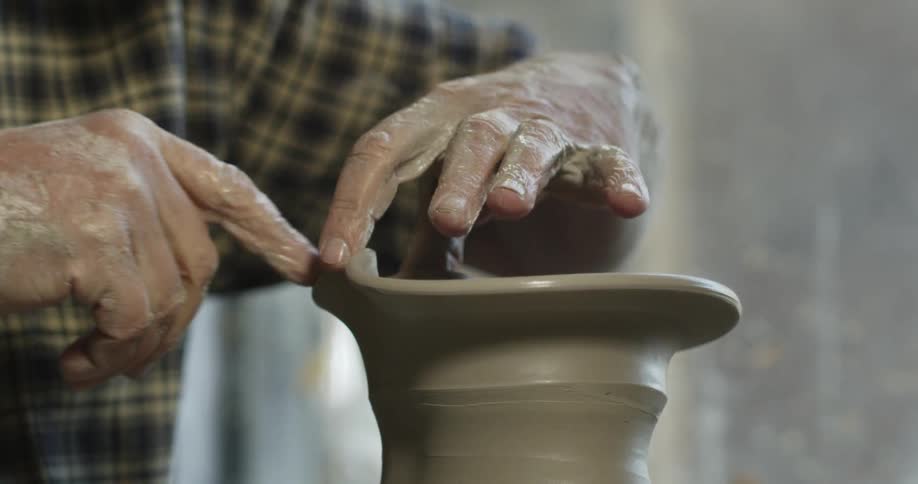 A man is making a bowl