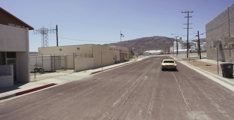 Car turns right and drives along an empty industrial street