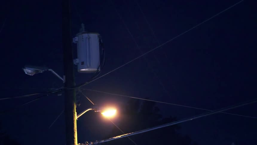 A street light and transformer are being filmed