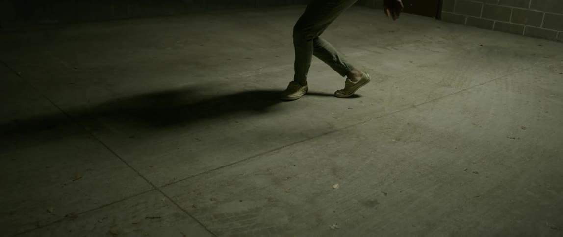 A man dances on concrete