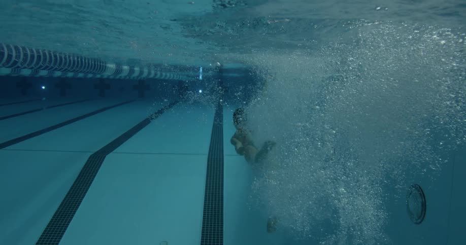 Woman dives into a swimming pool