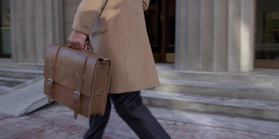 A businessman walks with a briefcase