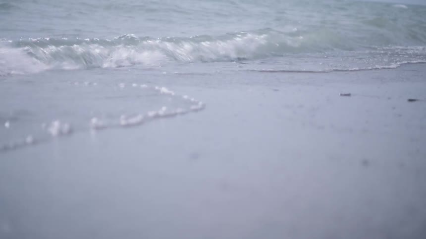 The waves splash against the shore slowly