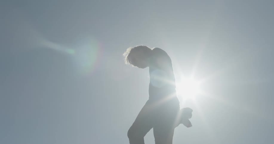 A man is walking outside balancing on something