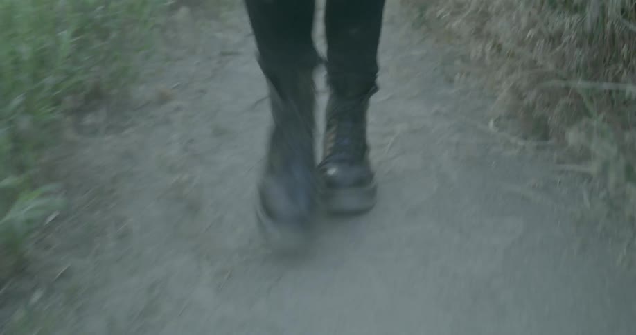 A person walks down a dirt path in boat