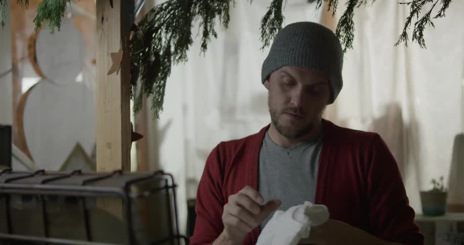 Someone is holding and folding baby clothes