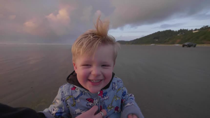 Child runs and laughs on the beach