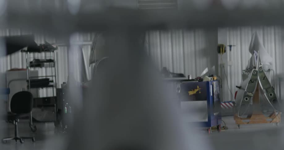 Pilot walks through an airport hangar