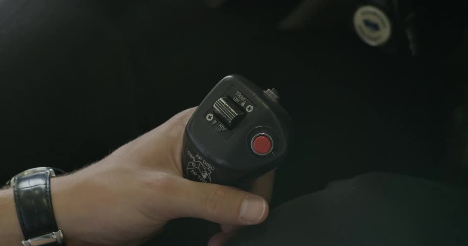 A pilot holds a hand controller in a small plane