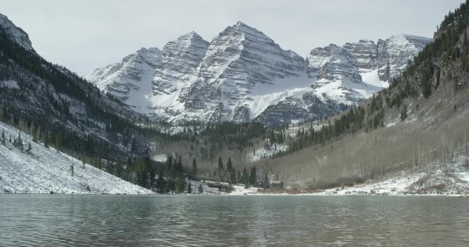 Body of water along maroon lake facing and snowy maroon bells