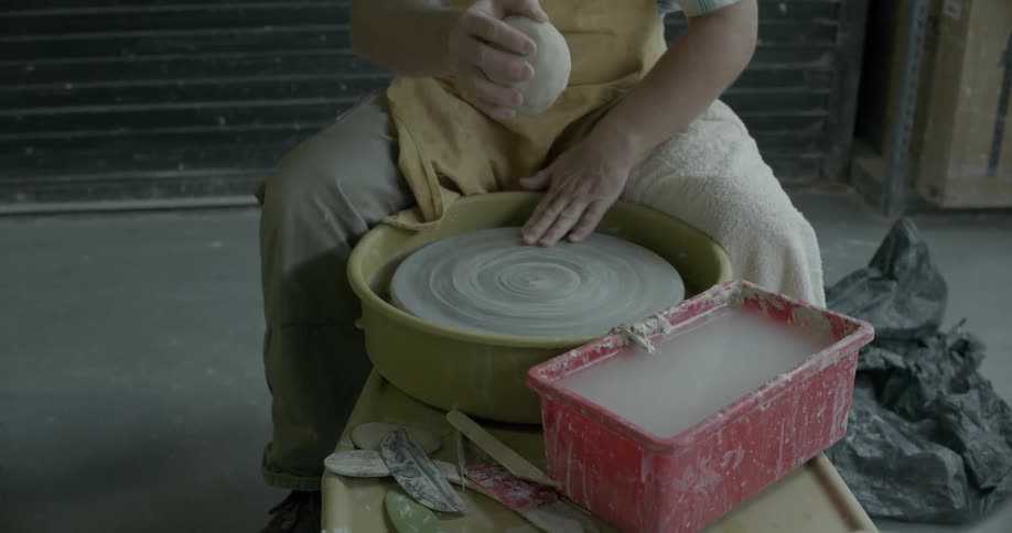 Man works on a pottery wheel