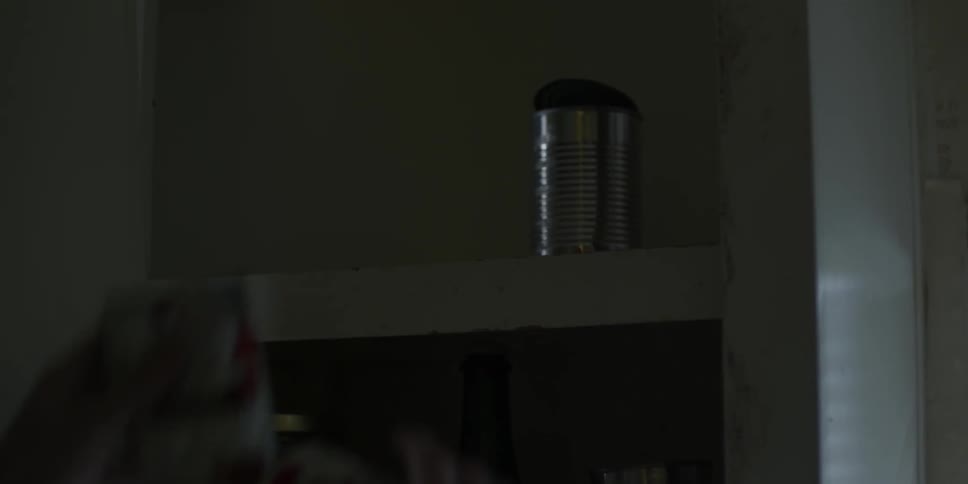 Man looks through canned food