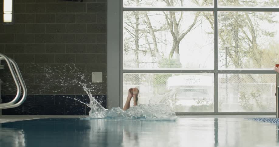A woman dives into a pool