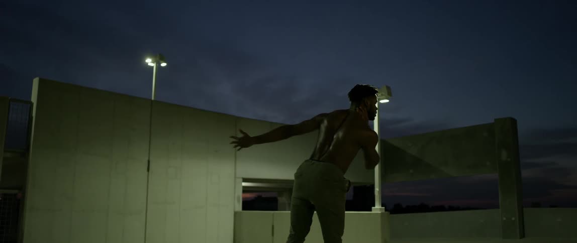 A man is dancing at night spinning around