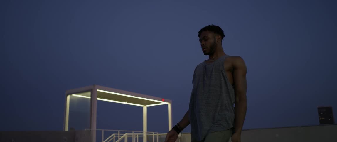 Man dances in city at night