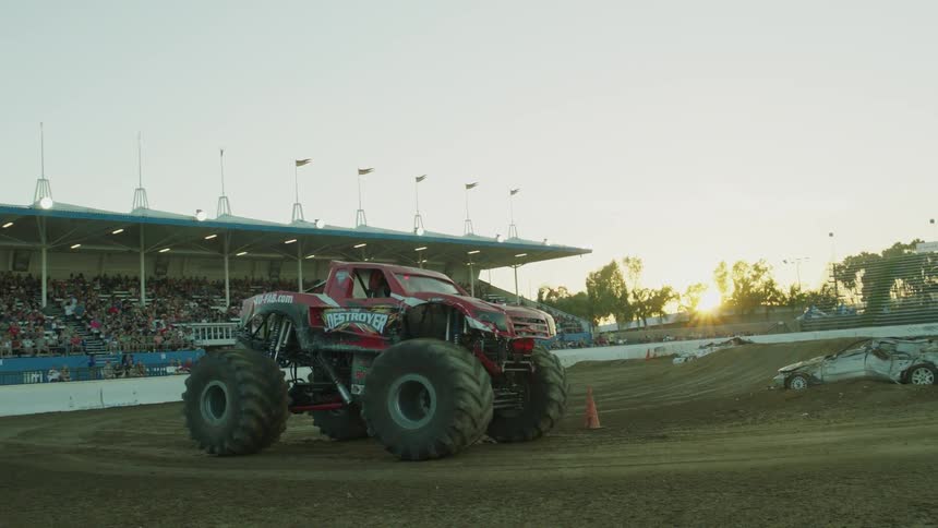 A monster truck is driving in the ring