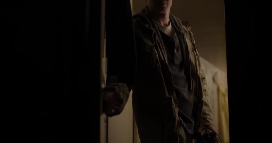 Someone is opening a door to a dark room