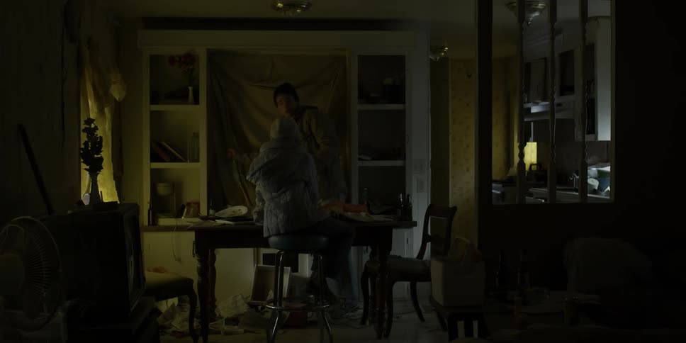 A man walks into a house and grabs a rifle