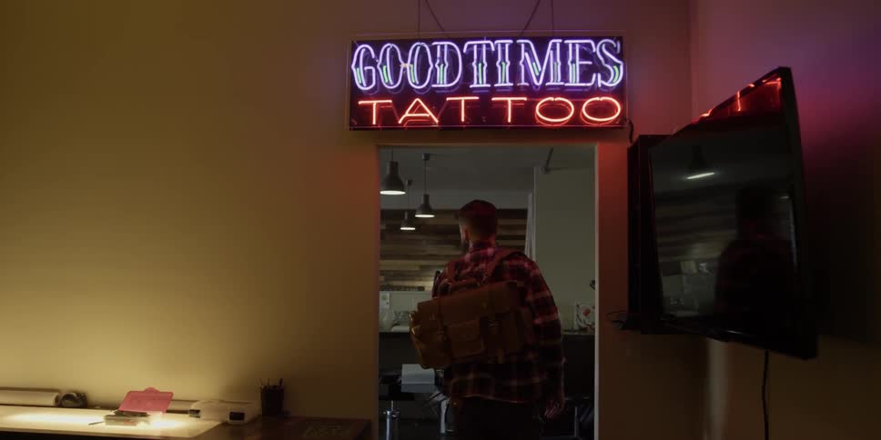 Man walks out of a tattoo shop