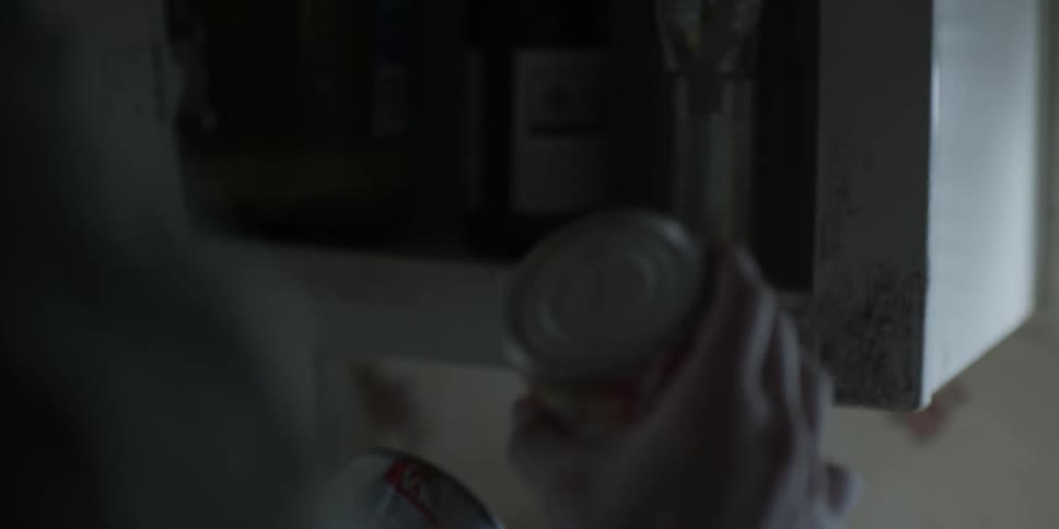 A person is holding a can in the kitchen