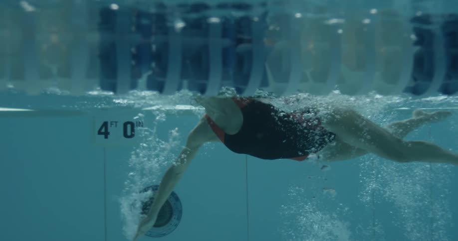Woman swims in a swimming pool