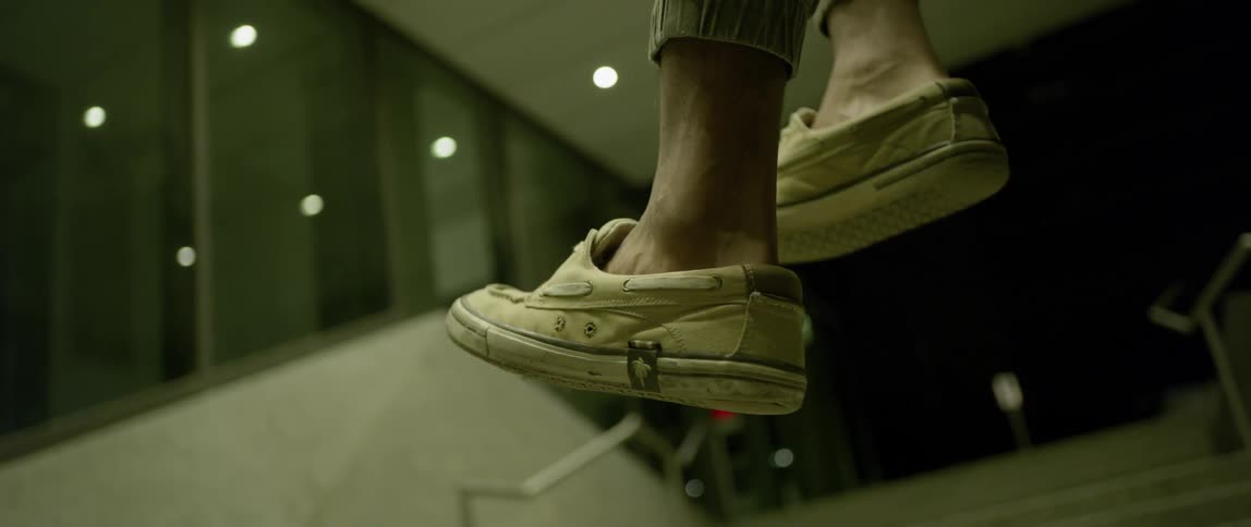 A person wearing slip on shoes is pretending to walk on air