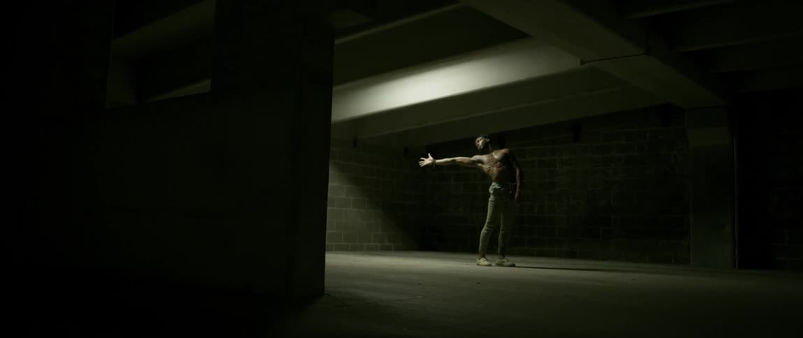 A man is dancing in the parking lot