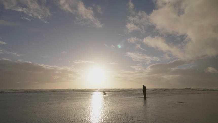 A man is walking on the water near the shore