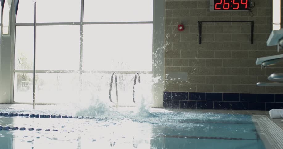A woman dives into the pool