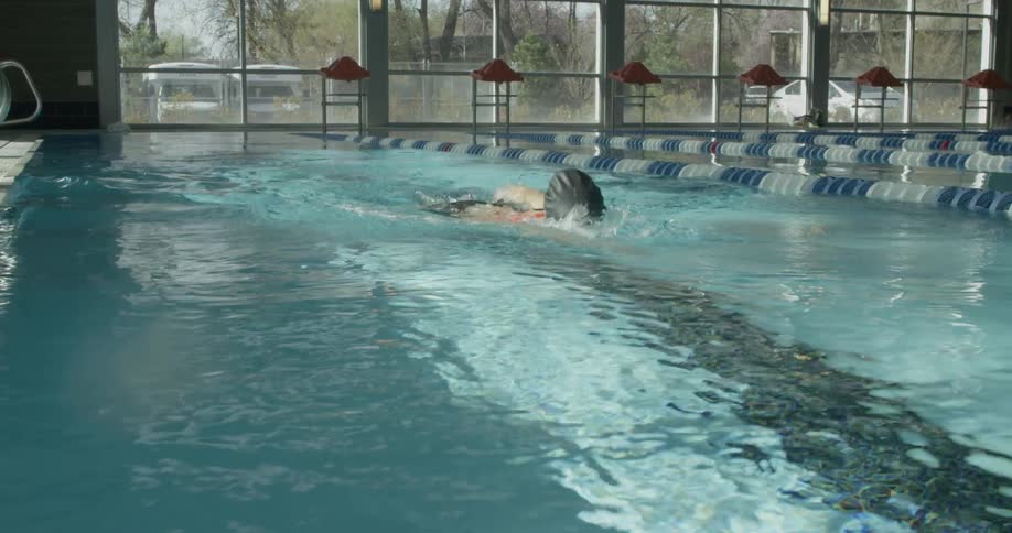 A woman is swimming past the camera