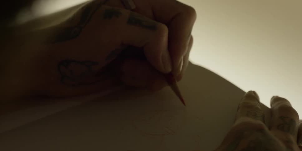 An artist sketches on paper
