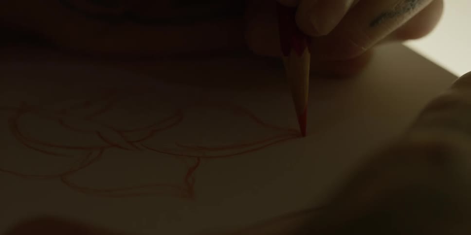 Person draws in red