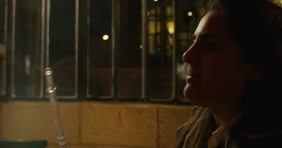 A woman is smoking a hookah