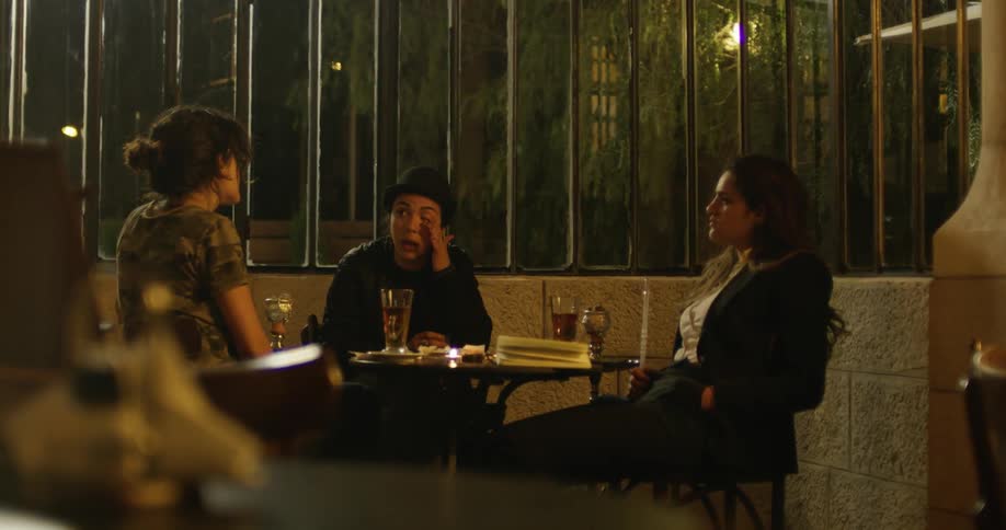 People are sitting down outside to drink and talk