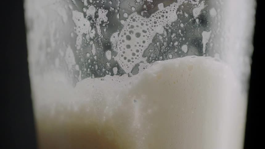 A glass is filled with beer