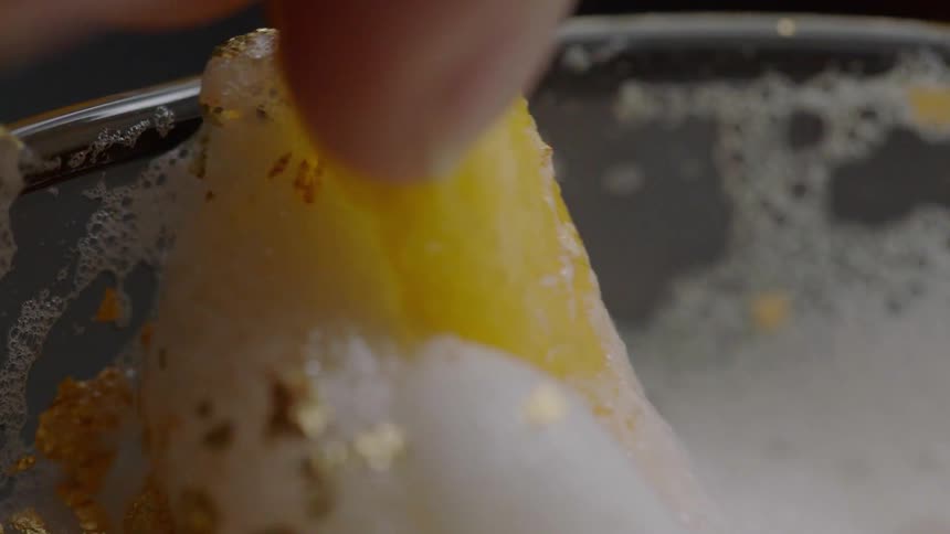 A foamy mixture with good flakes is being stirred with something yellow